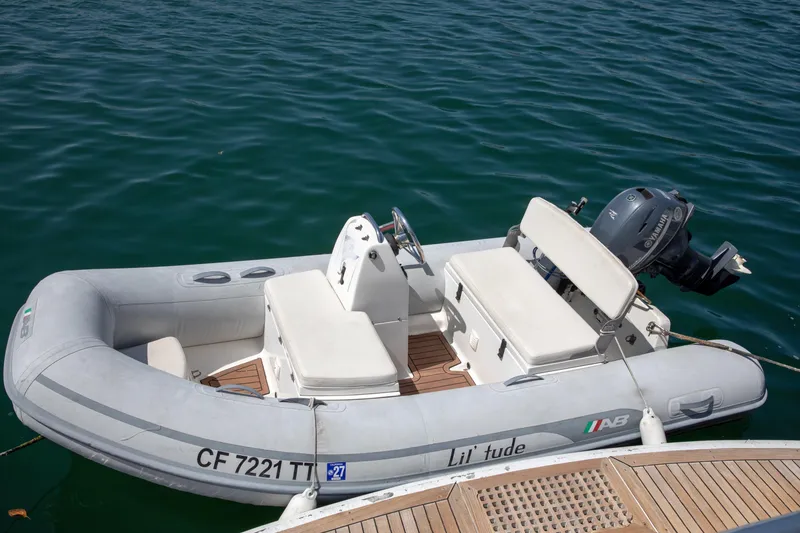 Slide: The Image of Inflatable dinghy with Yamaha outboard motor, docked beside a 2002 Hatteras 63 Raised Pilothouse Motor Yacht. - 14