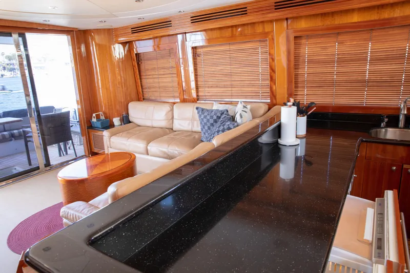Slide: The Image of Luxurious interior of 2002 Hatteras 63 Raised Pilothouse Motor Yacht with leather seating and wood accents. - 16