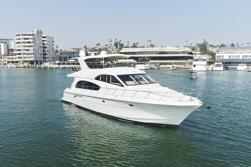 Slide: The Image of 2002 Hatteras 63 Raised Pilothouse Motor Yacht cruising in a marina. - 2