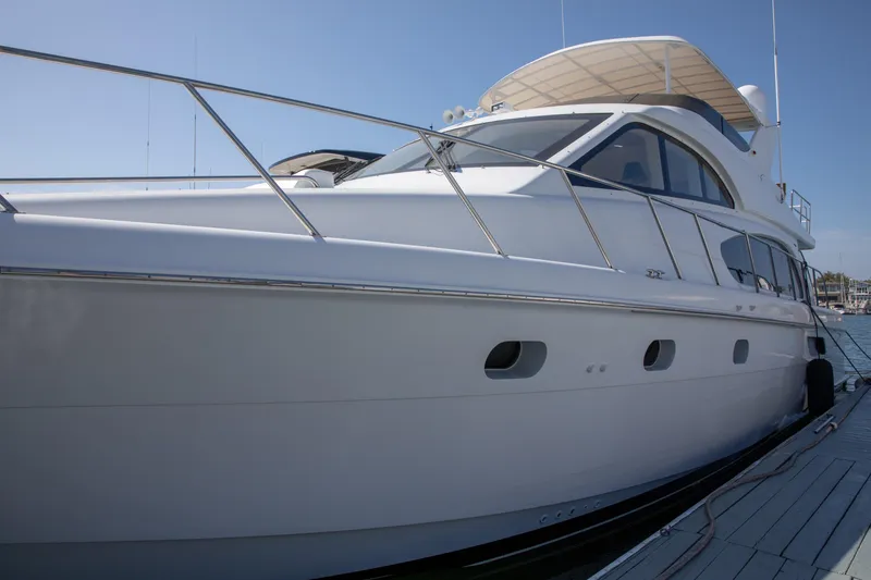 Slide: The Image of 2002 Hatteras 63 Raised Pilothouse Motor Yacht docked in sunny marina. - 3