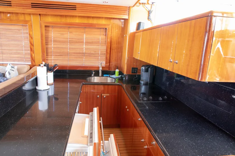 Slide: The Image of Luxurious kitchen interior of 2002 Hatteras 63 Raised Pilothouse Motor Yacht with sleek wood cabinetry. - 37