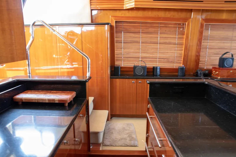 Slide: The Image of Luxurious kitchen interior of 2002 Hatteras 63 Raised Pilothouse Motor Yacht with wood cabinetry. - 39
