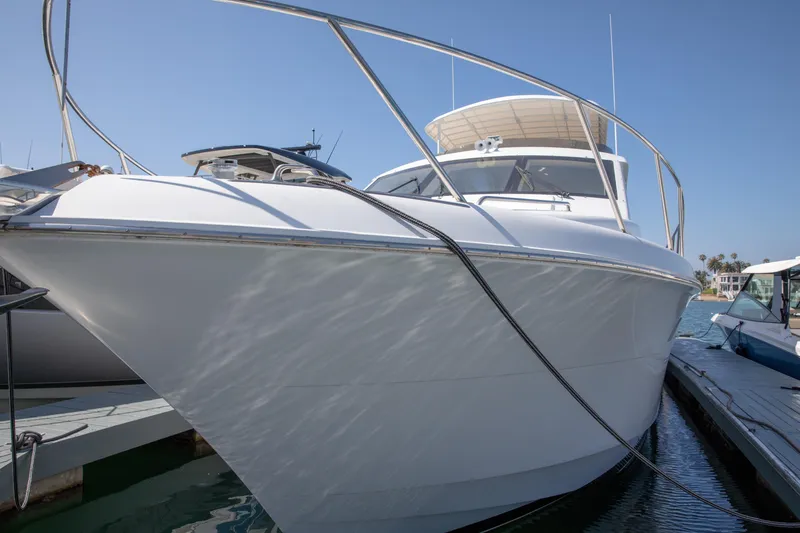 Slide: The Image of 2002 Hatteras 63 Raised Pilothouse Motor Yacht docked at marina under clear blue sky. - 4