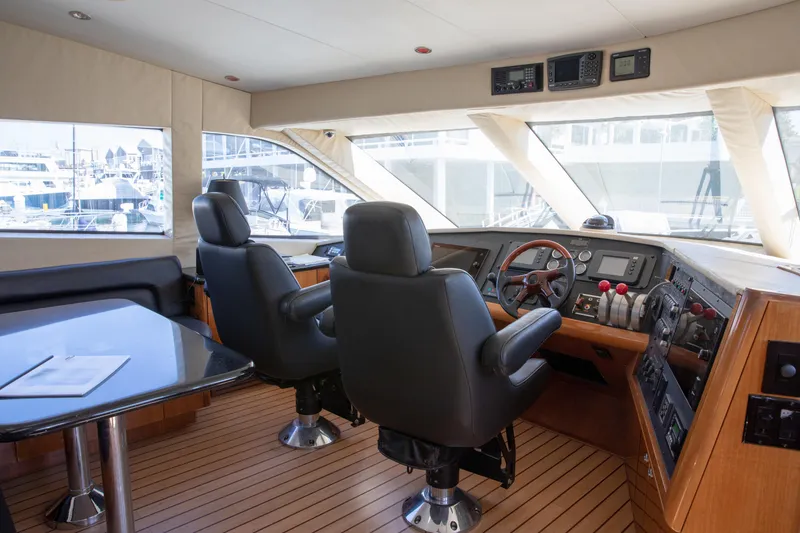 Slide: The Image of Pilothouse interior of 2002 Hatteras 63 Raised Pilothouse Motor Yacht with helm and seating area. - 42