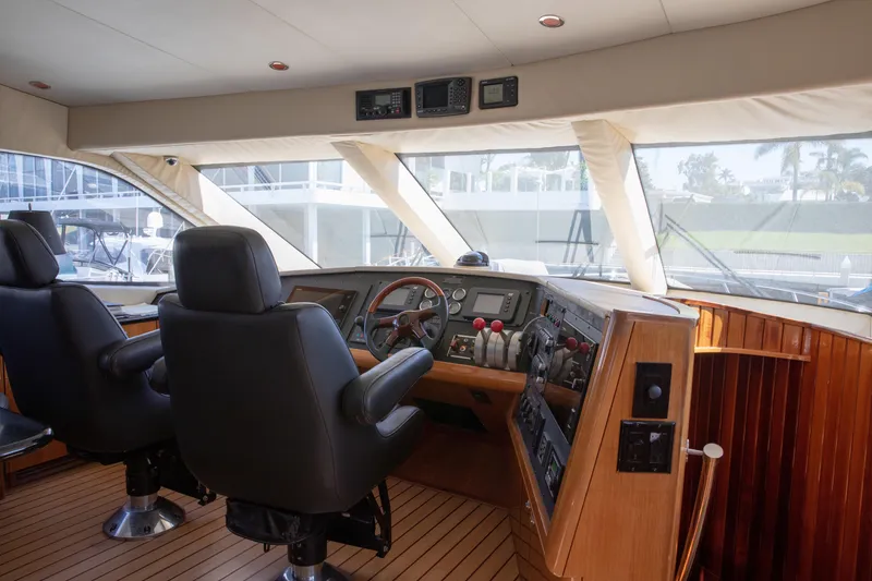 Slide: The Image of Interior of 2002 Hatteras 63 Raised Pilothouse Motor Yacht cockpit with leather seats and control panel. - 43