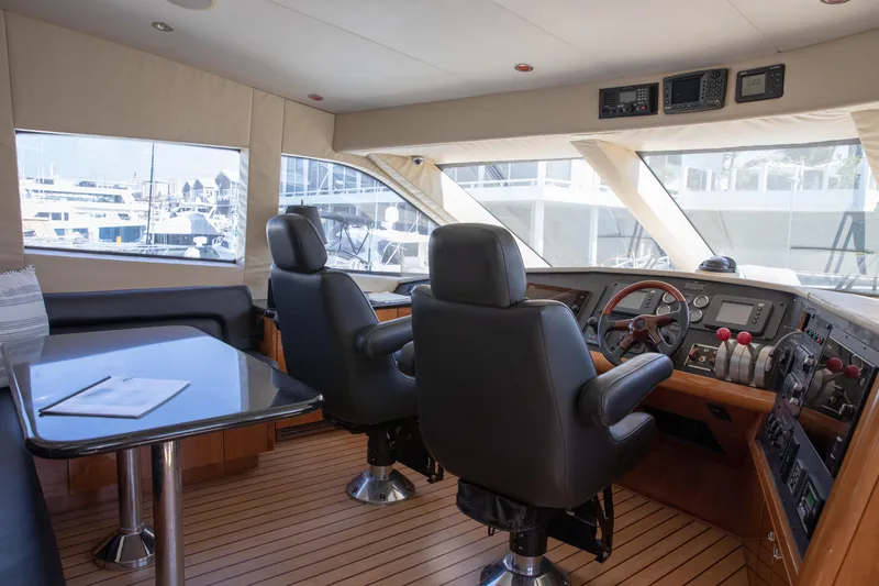Slide: The Image of Pilothouse interior of 2002 Hatteras 63 Raised Pilothouse Motor Yacht, featuring helm and seating area. - 45