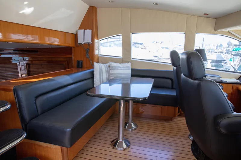 Slide: The Image of Luxurious interior of 2002 Hatteras 63 Raised Pilothouse Motor Yacht with leather seating and wooden accents. - 46