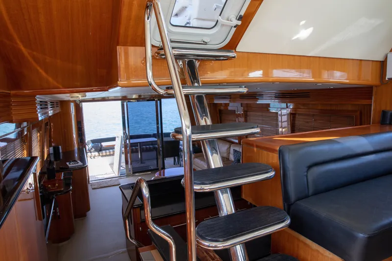 Slide: The Image of Luxurious interior of 2002 Hatteras 63 Raised Pilothouse Motor Yacht with sleek staircase and seating. - 47