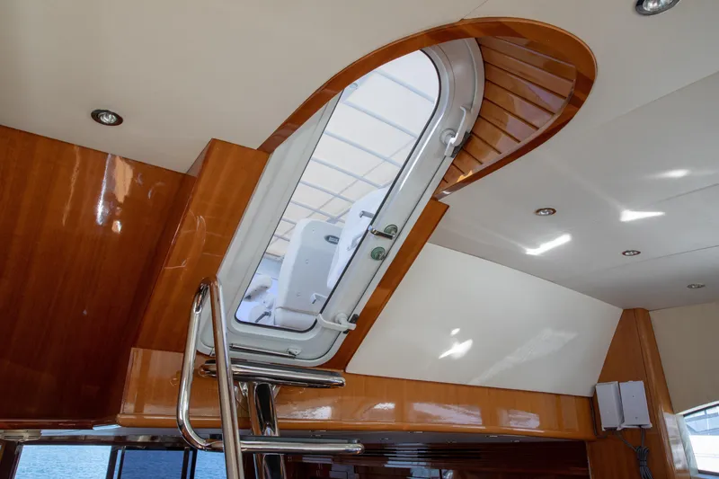Slide: The Image of Interior view of 2002 Hatteras 63 Raised Pilothouse Motor Yacht with wooden finishes and hatch. - 49