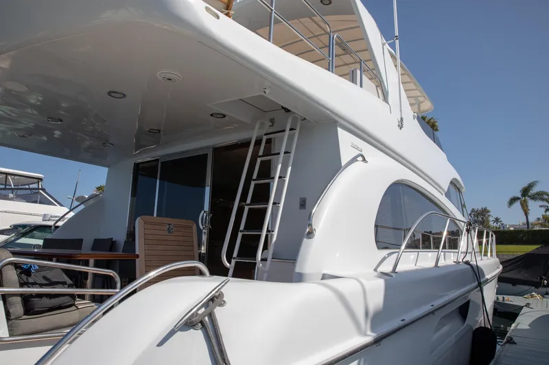 Slide: The Image of 2002 Hatteras 63 Raised Pilothouse Motor Yacht, sleek design, docked under clear blue sky. - 5