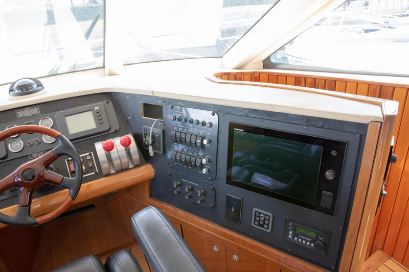Slide: The Image of Pilothouse of 2002 Hatteras 63 Raised Motor Yacht with steering wheel and control panel. - 51