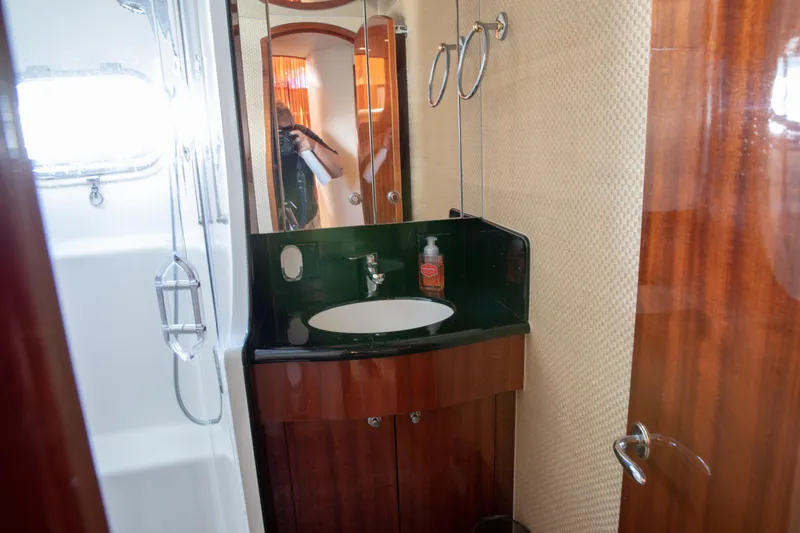 Slide: The Image of Luxurious bathroom in 2002 Hatteras 63 Raised Pilothouse Motor Yacht with elegant wood finishes. - 55