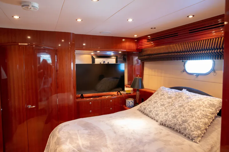Slide: The Image of Luxurious bedroom interior of 2002 Hatteras 63 Raised Pilothouse Motor Yacht with elegant wood finish. - 57