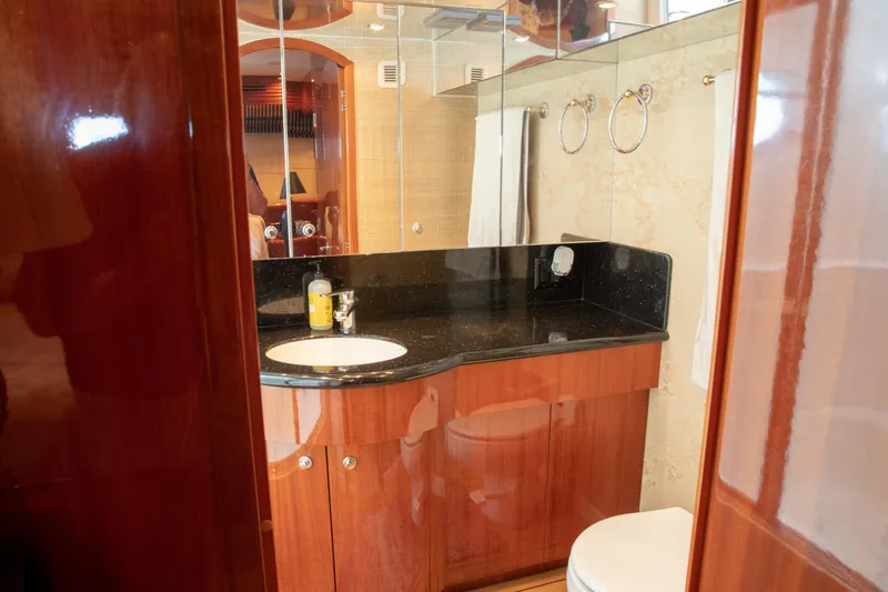 Slide: The Image of Luxurious bathroom in 2002 Hatteras 63 Raised Pilothouse Motor Yacht with wood cabinetry. - 58