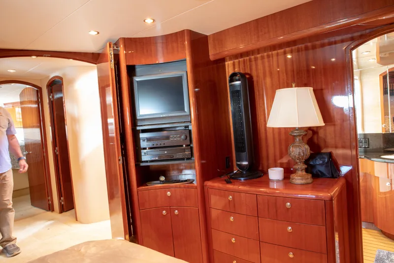 Slide: The Image of Luxurious interior of 2002 Hatteras 63 Raised Pilothouse Motor Yacht with wood cabinetry and entertainment center. - 59