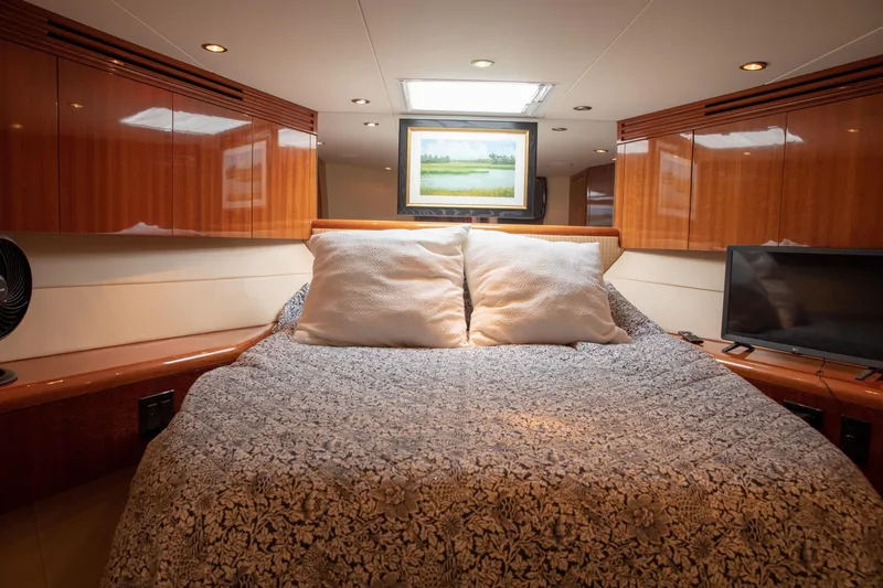 Slide: The Image of Luxurious bedroom interior of 2002 Hatteras 63 Raised Pilothouse Motor Yacht with elegant wood finishes. - 62