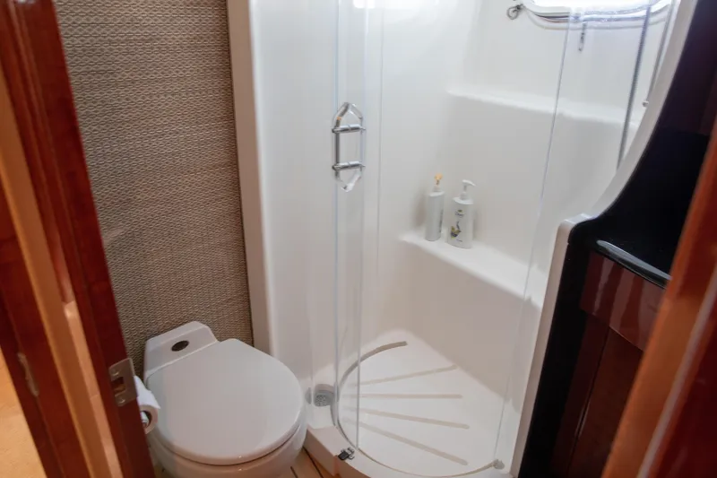 Slide: The Image of Bathroom in 2002 Hatteras 63 Raised Pilothouse Motor Yacht with shower and toilet. - 63