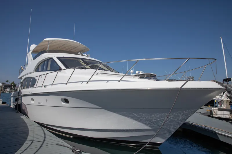 Slide: The Image of 2002 Hatteras 63 Raised Pilothouse Motor Yacht docked under clear blue sky. - 7