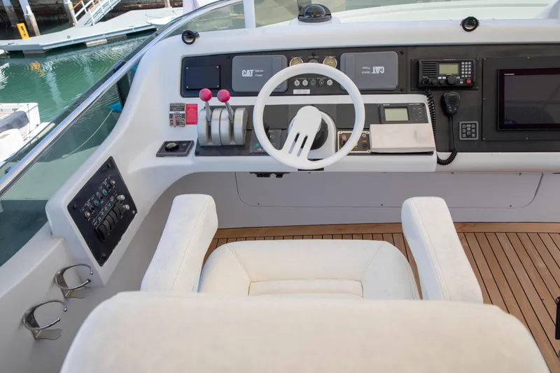 Slide: The Image of Helm of 2002 Hatteras 63 Raised Pilothouse Motor Yacht with steering wheel and controls. - 79
