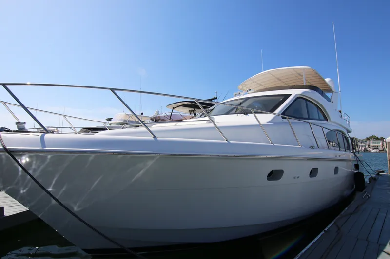 Slide: The Image of 2002 Hatteras 63 Raised Pilothouse Motor Yacht docked under clear blue sky. - 8