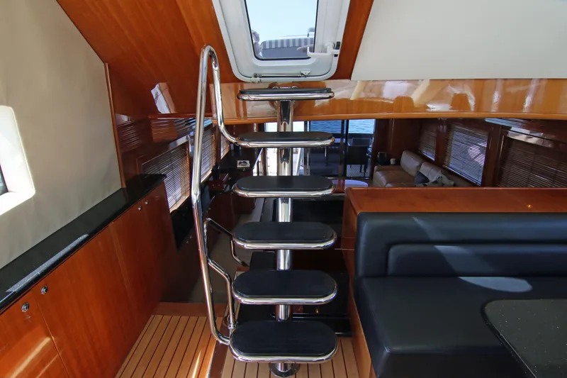Slide: The Image of Interior of 2002 Hatteras 63 Raised Pilothouse Motor Yacht with modern staircase and seating. - 87