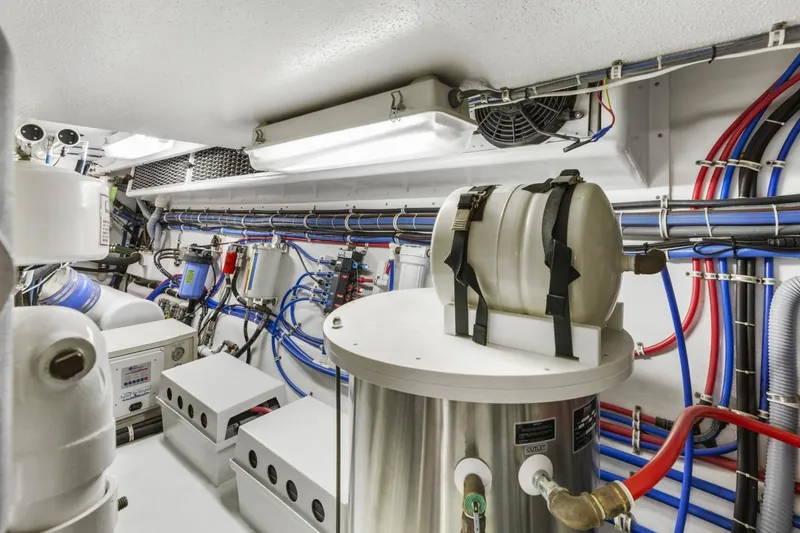 Slide: The Image of Engine room of 2002 Hatteras 63 Raised Pilothouse Motor Yacht with complex piping and equipment. - 91