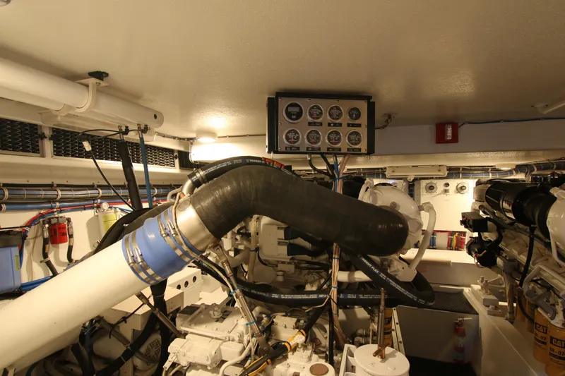 Slide: The Image of Engine room of 2002 Hatteras 63 Raised Pilothouse Motor Yacht with gauges and machinery. - 92