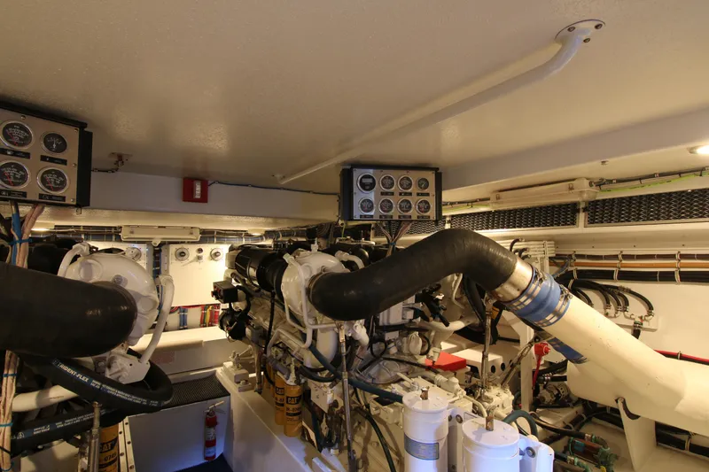 Slide: The Image of Engine room of 2002 Hatteras 63 Raised Pilothouse Motor Yacht, showcasing machinery and gauges. - 93