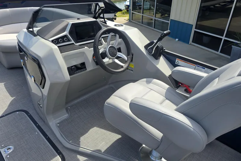Slide: The Image of Captain's helm of 2022 Manitou 23 Encore RF boat with modern controls and seating. - 11