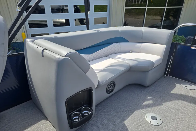 Slide: The Image of Luxurious seating on 2022 Manitou 23 Encore RF pontoon boat, featuring cup holders and modern design. - 16