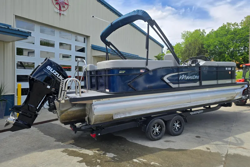 Slide: The Image of 2022 Manitou 23 Encore RF pontoon boat with Suzuki engine on trailer. - 3
