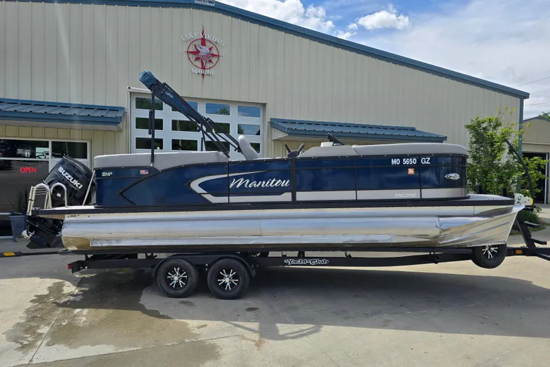 Slide: The Image of 2022 Manitou 23 Encore RF pontoon boat on trailer outside Lake Viking Marine. - 4