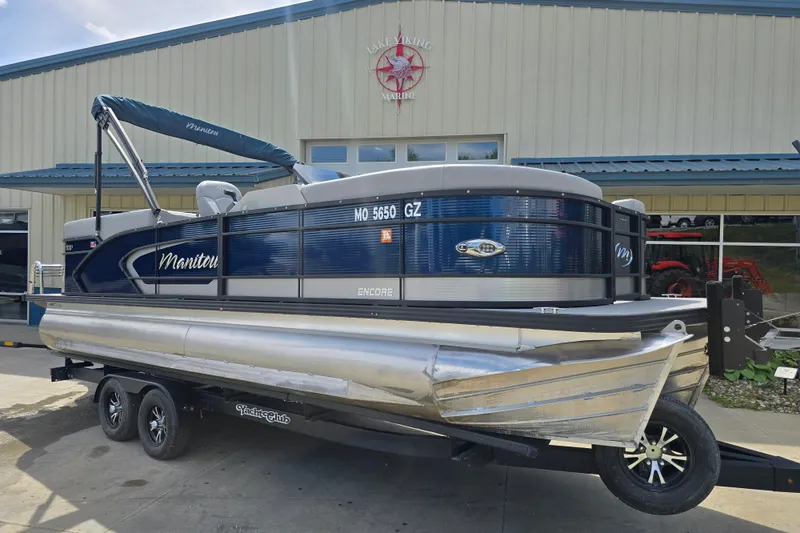Slide: The Image of 2022 Manitou 23 Encore RF pontoon boat on trailer outside dealership. - 5