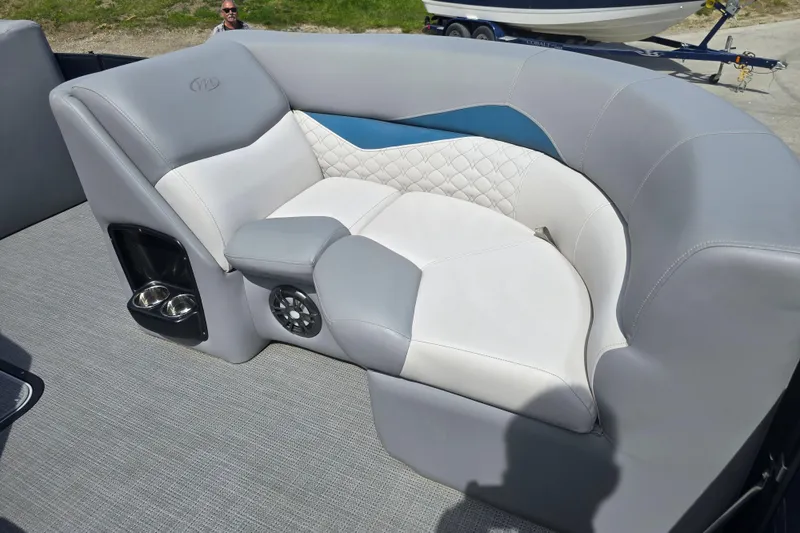 Slide: The Image of Luxurious seating on 2022 Manitou 23 Encore RF pontoon boat with cup holders and speaker. - 9