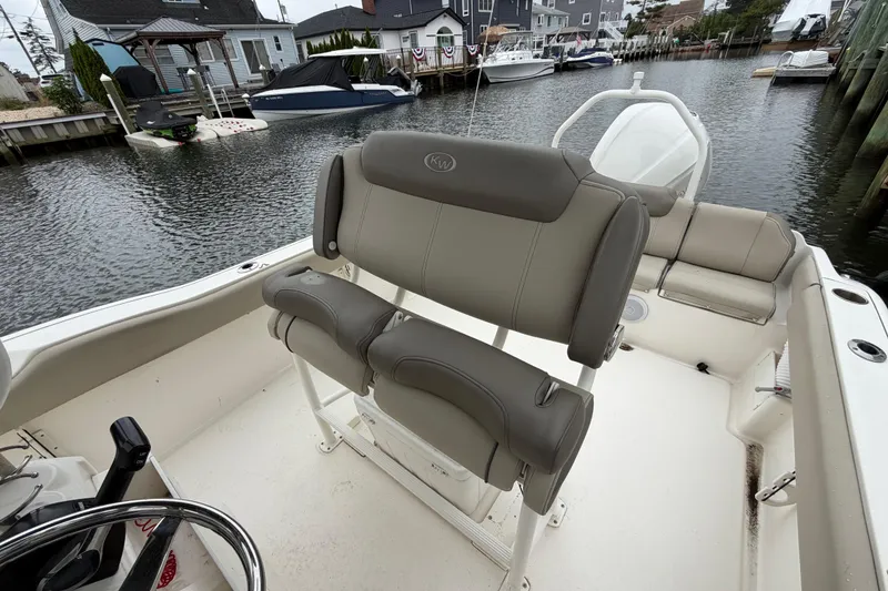 Slide: The Image of 2022 Key West 239 FS boat interior with seating, docked in a marina. - 10