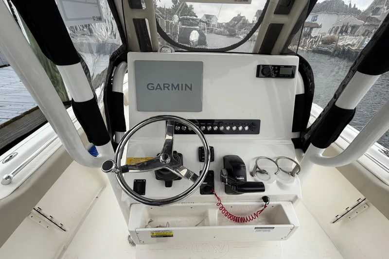 Slide: The Image of 2022 Key West 239 FS boat console with Garmin navigation and steering wheel. - 12