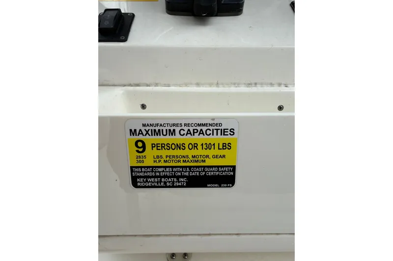 Slide: The Image of 2022 Key West 239 FS boat capacity label, maximum 9 persons or 1301 lbs. - 20