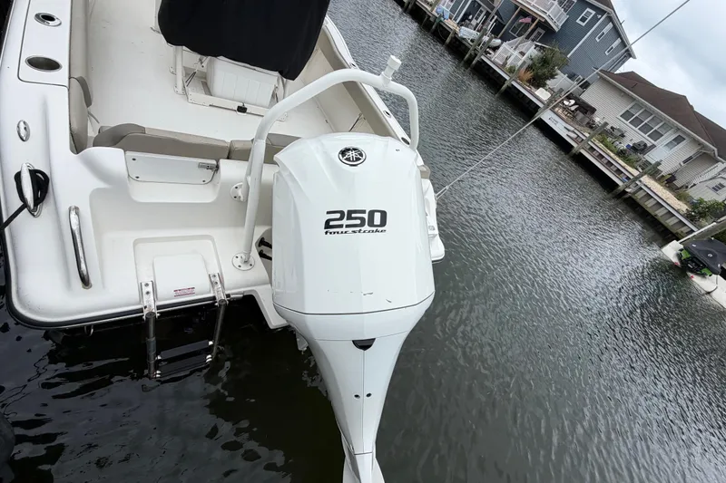 Slide: The Image of 2022 Key West 239 FS boat with Yamaha 250 outboard motor docked by waterfront homes. - 21