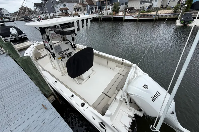 Slide: The Image of 2022 Key West 239 FS boat docked, featuring Yamaha 250 engine, in a residential marina. - 7
