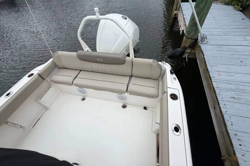 Slide: The Image of 2022 Key West 239 FS boat docked, featuring spacious seating and sleek design. - 8