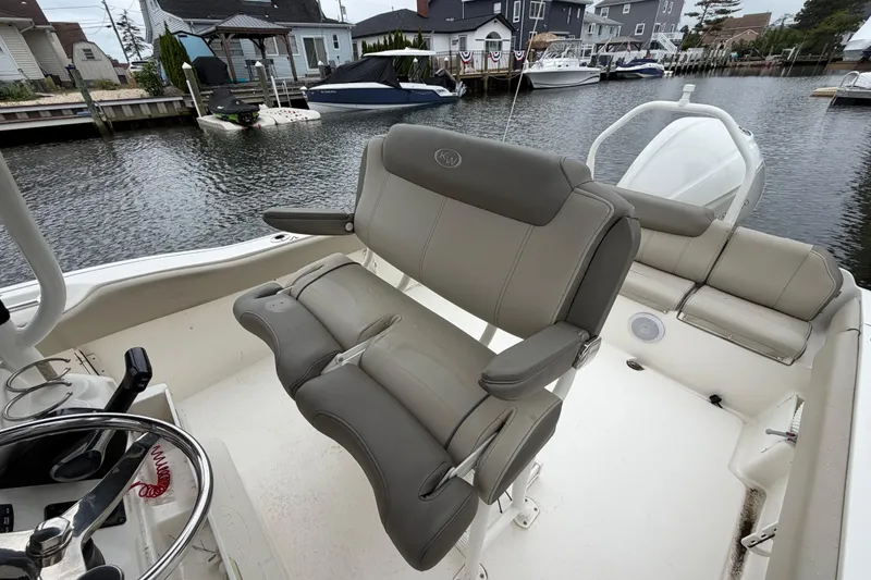 Slide: The Image of 2022 Key West 239 FS boat interior with comfortable seating and steering wheel. - 9