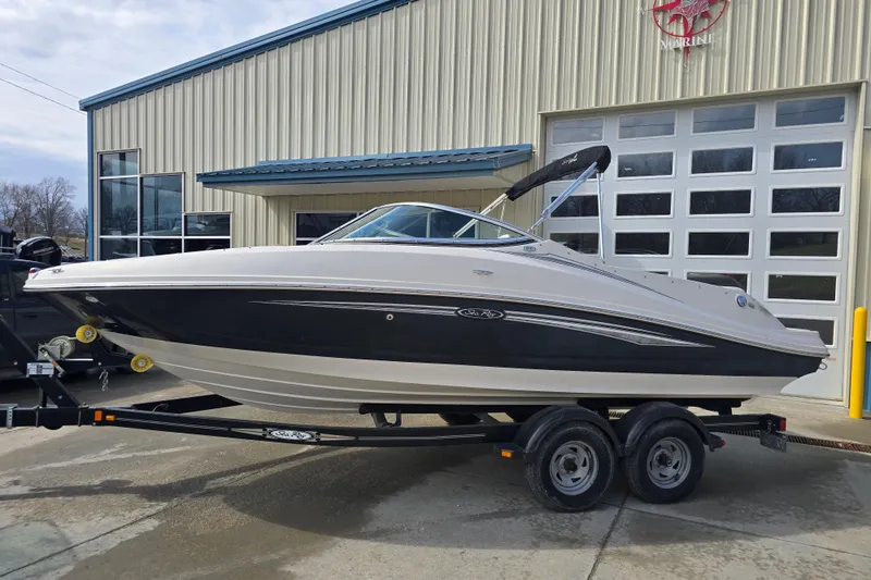 The Image of 2007 Sea Ray 210 Select boat on trailer outside a marine facility. - 0