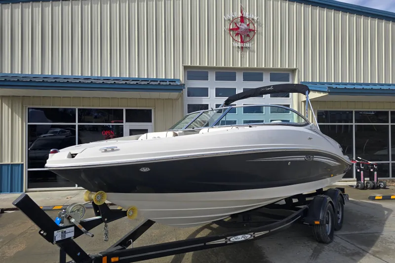 Slide: The Image of 2007 Sea Ray 210 Select boat on trailer outside marine dealership. - 1