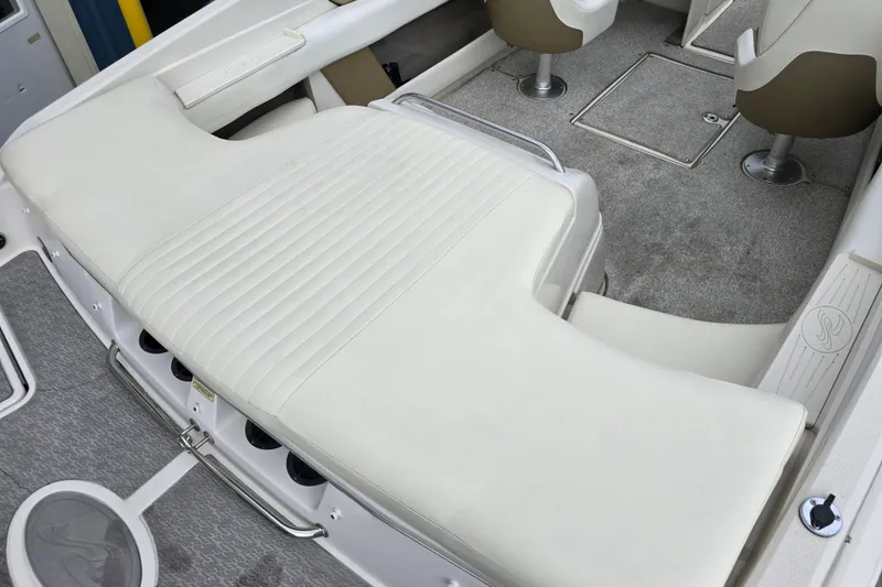Slide: The Image of Interior of a 2007 Sea Ray 210 Select boat with white seating and carpeted floor. - 10