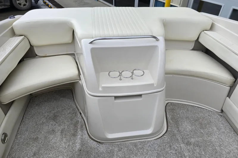 Slide: The Image of Interior of a 2007 Sea Ray 210 Select boat with white seating and carpeted floor. - 11