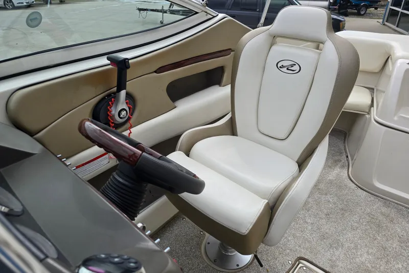 Slide: The Image of Interior of a 2007 Sea Ray 210 Select boat, featuring a captain's chair and steering controls. - 13