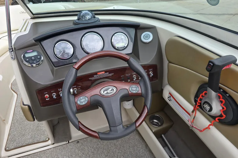 Slide: The Image of Steering console of a 2007 Sea Ray 210 Select boat with gauges and controls. - 14
