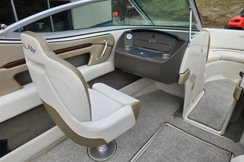 Slide: The Image of Interior of a 2007 Sea Ray 210 Select boat, featuring helm and seating area. - 15
