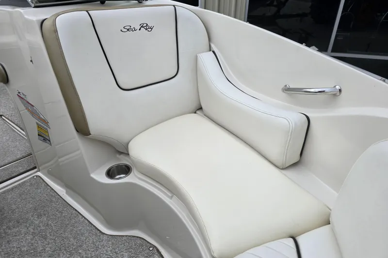 Slide: The Image of 2007 Sea Ray 210 Select boat interior with white cushioned seating. - 19