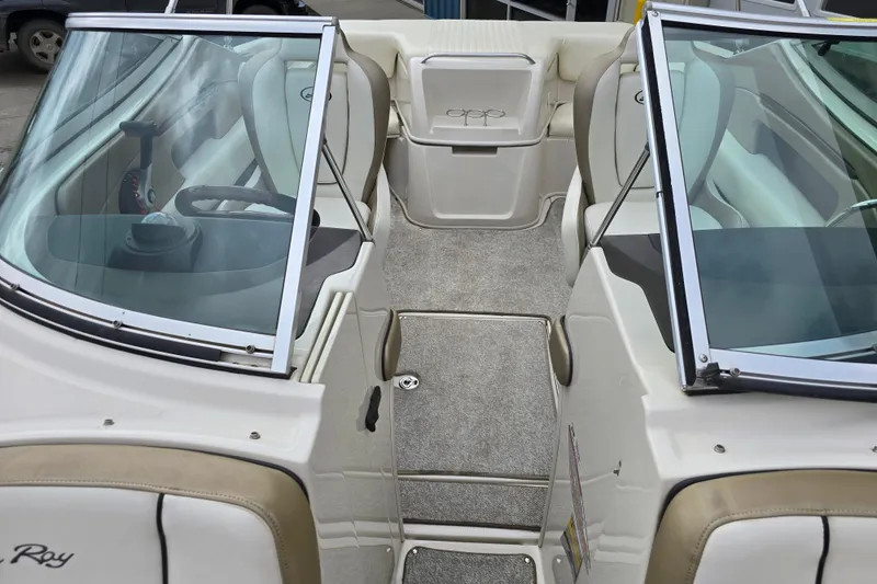 Slide: The Image of 2007 Sea Ray 210 Select boat interior with beige seating and windshield. - 21